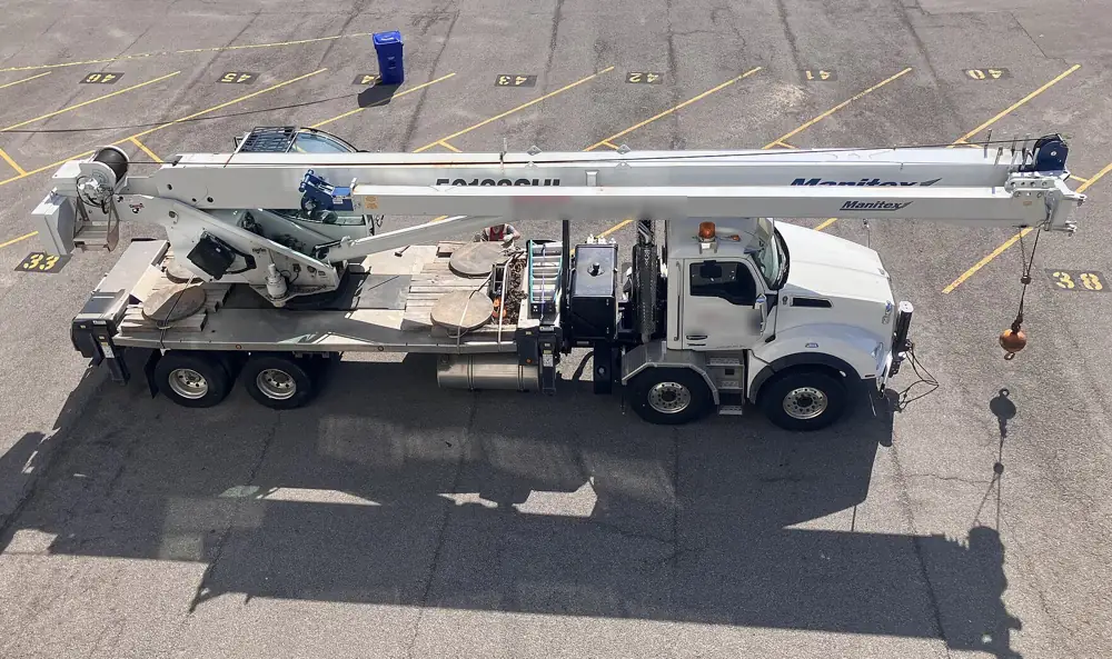 Telescopic boom truck crane parked with outriggers