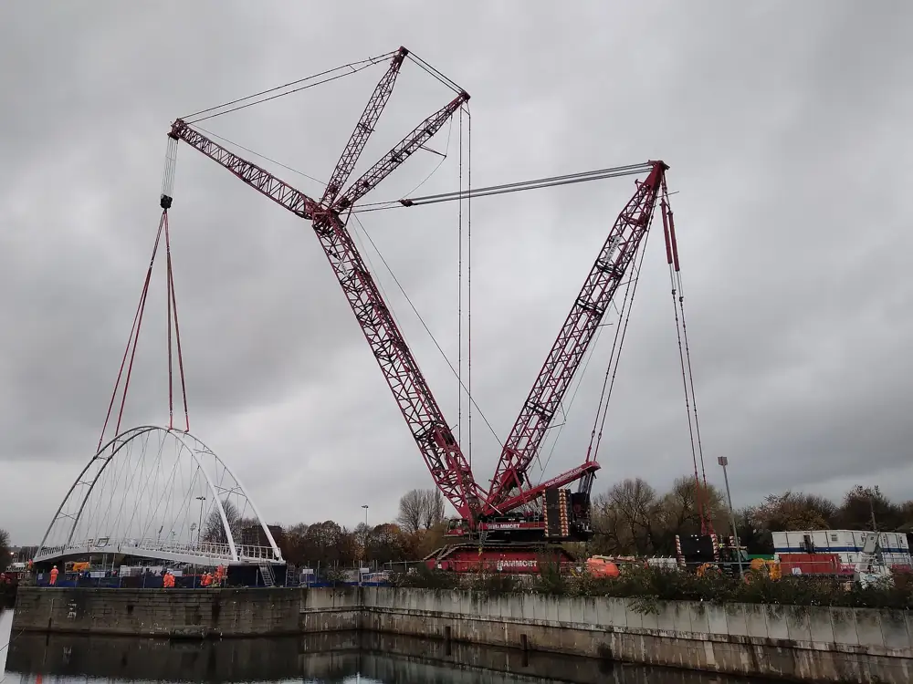 Crawler crane lifting a bridge section into place