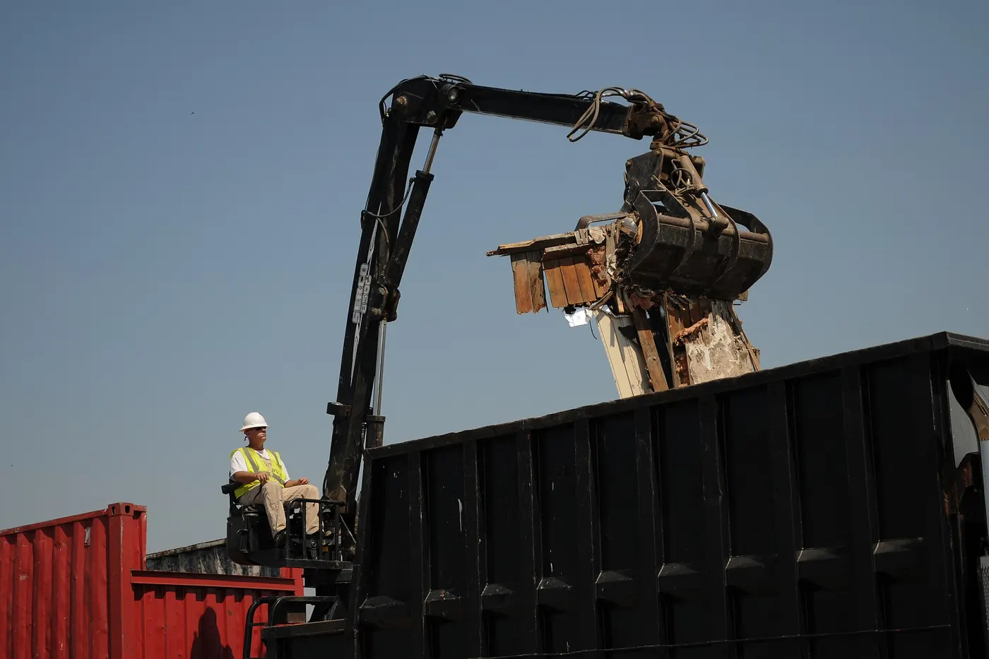 Knuckle-boom grapple loading debris into a trailer during the Joplin tornado cleanup