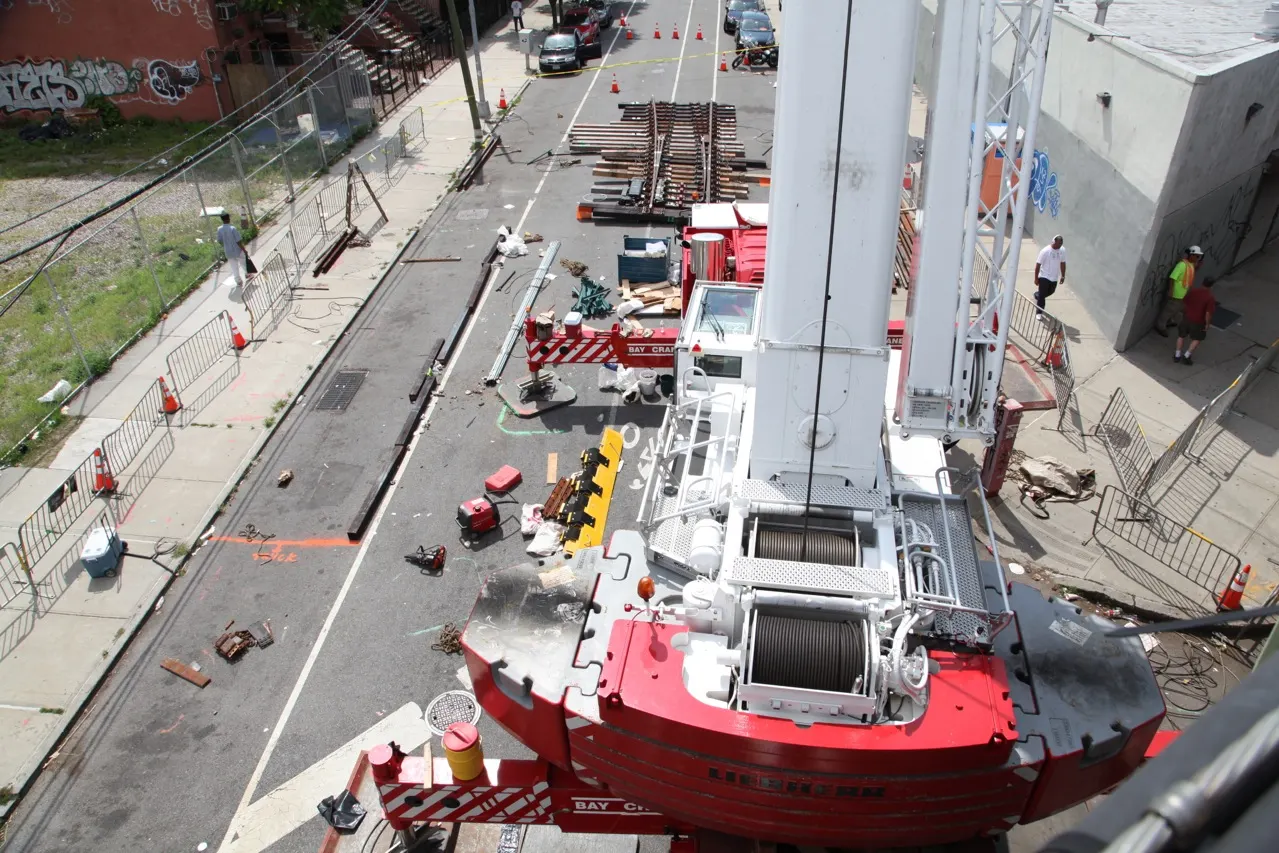 Mobile crane set up on a building job site, seen from above